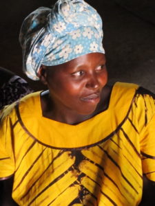 Mother attending outreach clinics in bright yellow